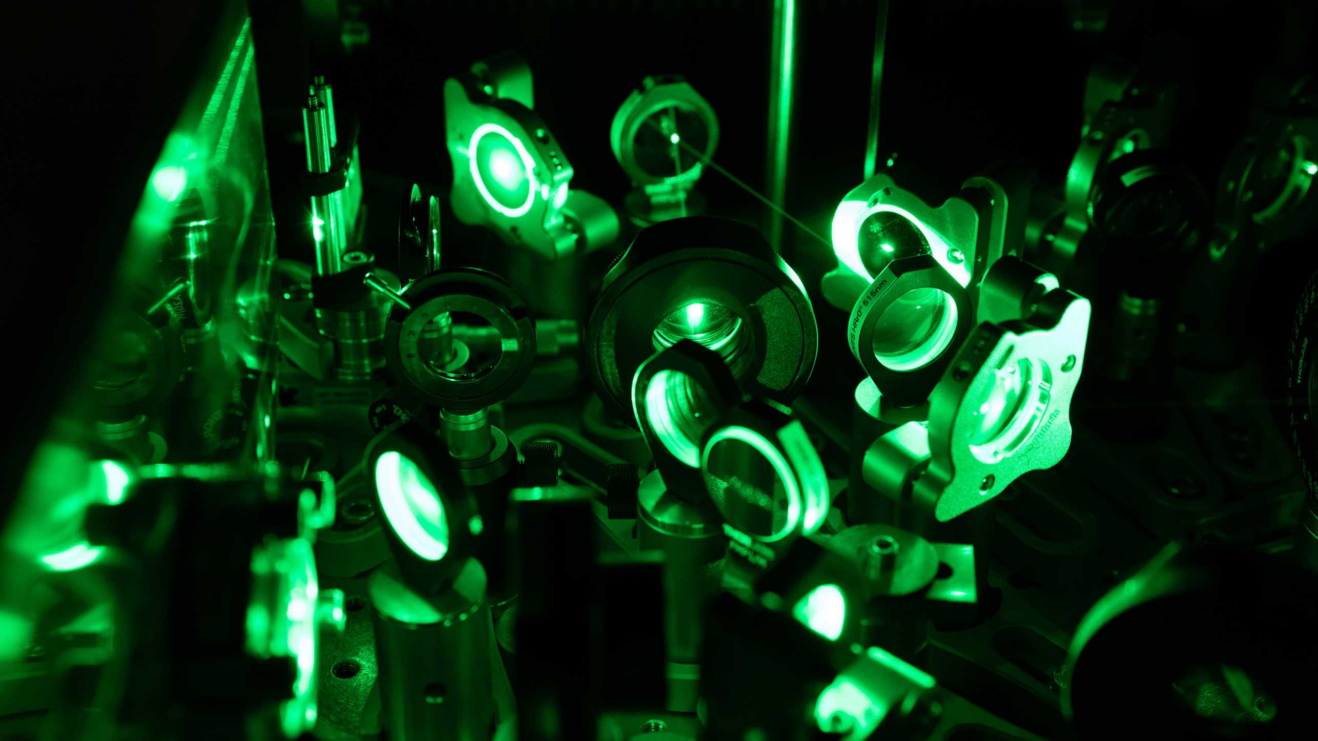 Green laser beam on mirrors and lenses